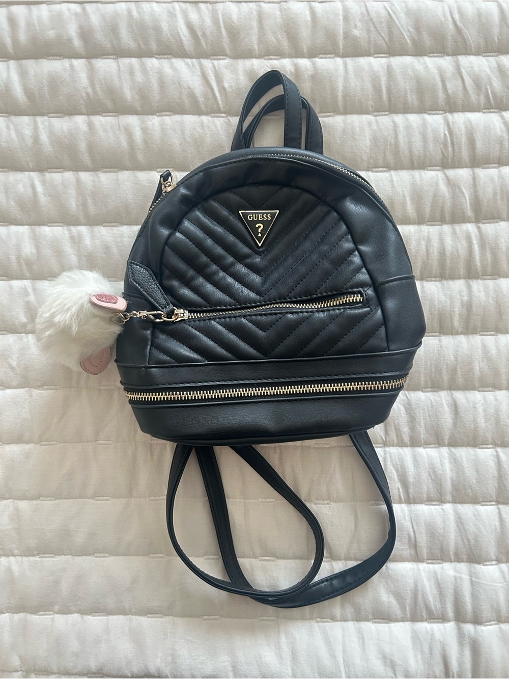 GUESS Black Quilted Mini Backpack with Gold Accents and Pom Charm